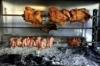 The charcoal grill in a taverna restaurant in Crete, Greece, with chickens, pork and lamb spit roasting stock photography
